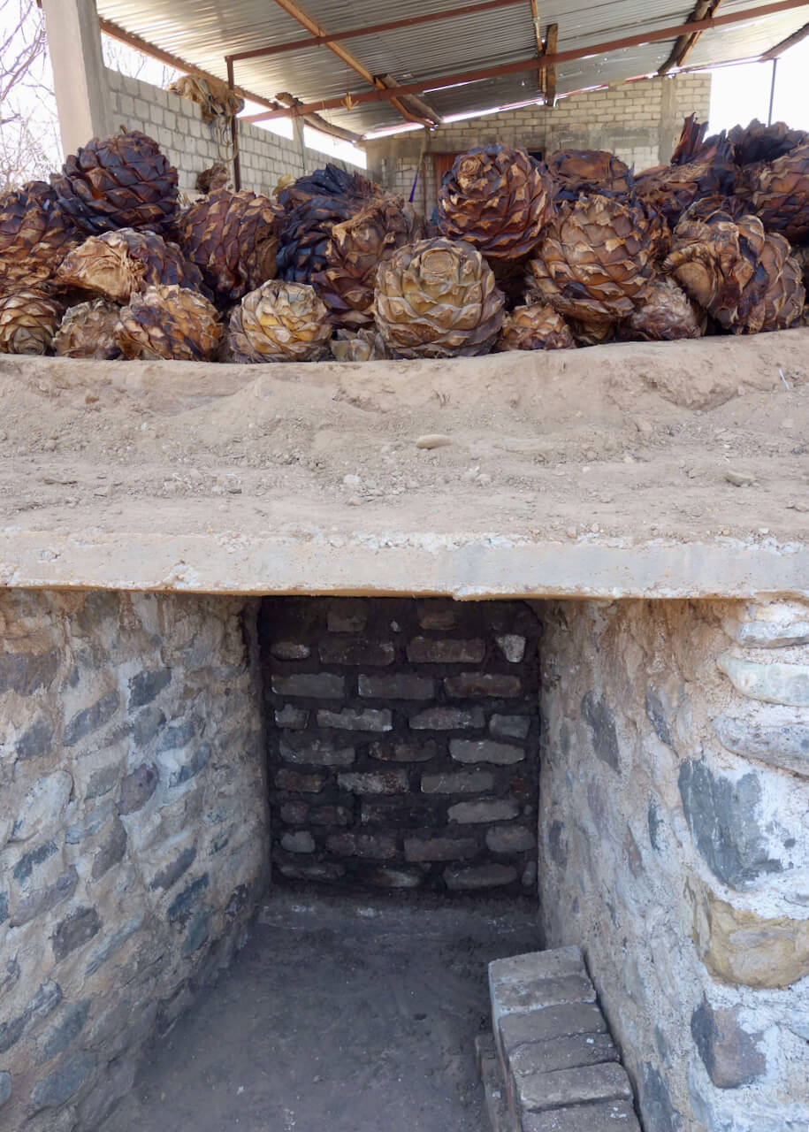 The underside of a mezcal cooking pit where firewood is placed