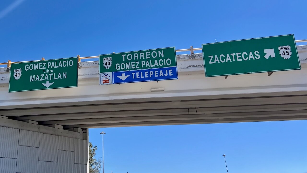 Highway signs pointing to Torreon and other cities